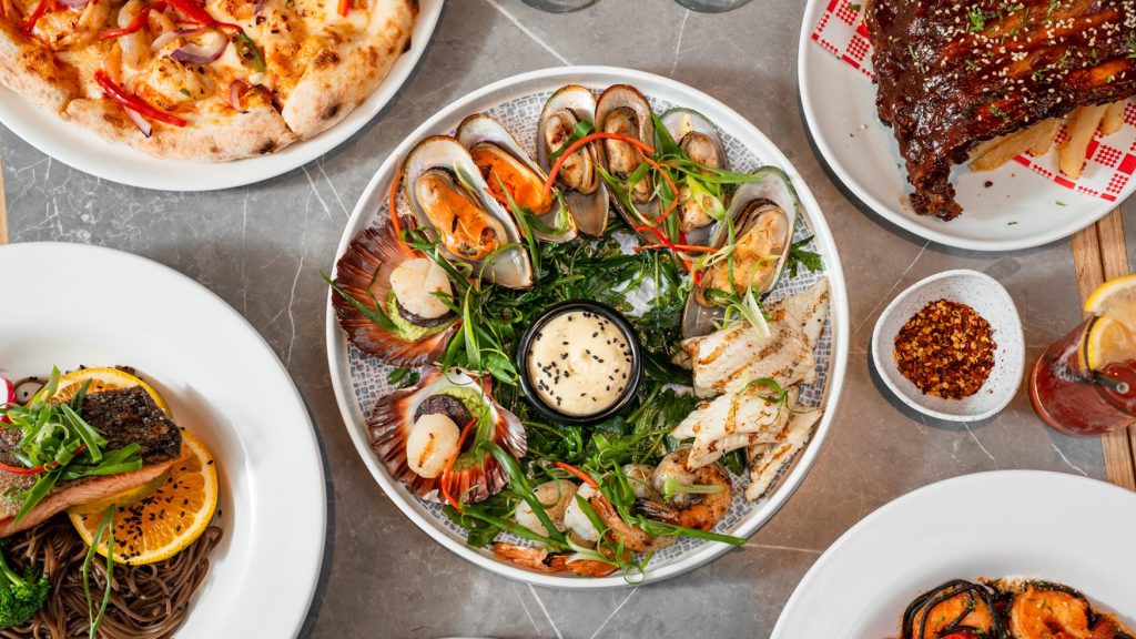 Seafood platter with mussels, scallops, prawns, and dipping sauce