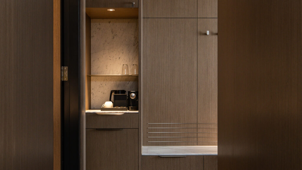 Minibar nook with a coffee machine and glassware in the Presidential Suite at Novotel Sydney Cabramatta
