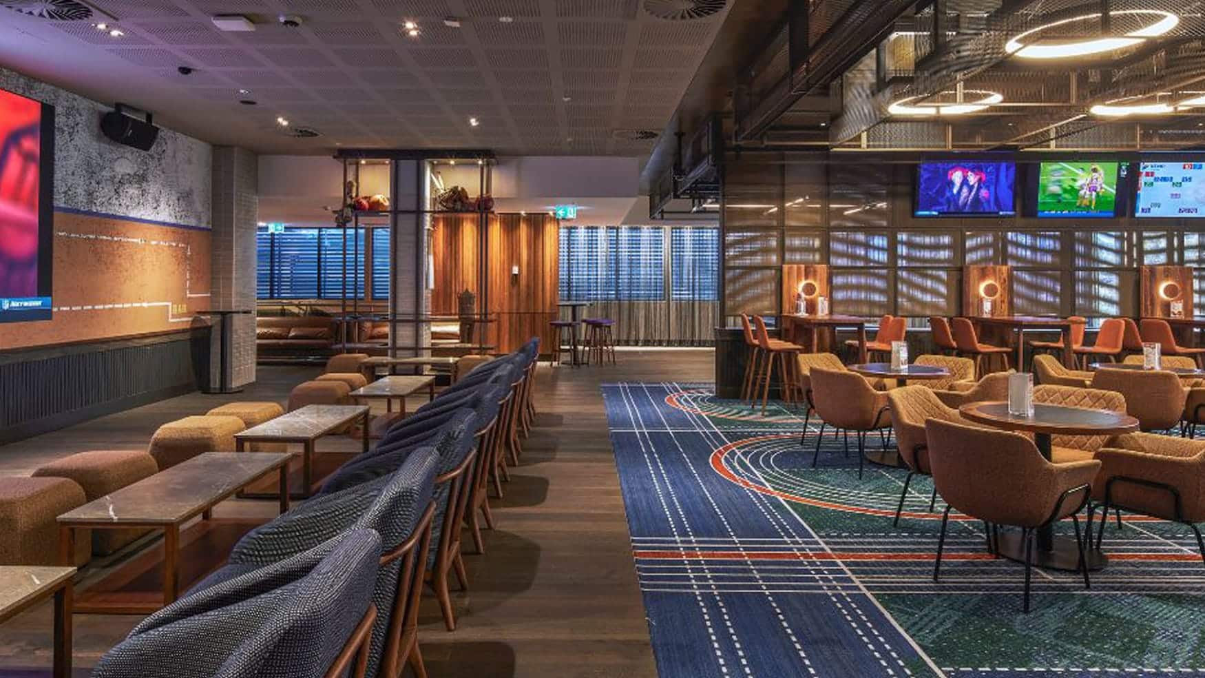 Modern lounge and dining area in the watch room at Sports Arena