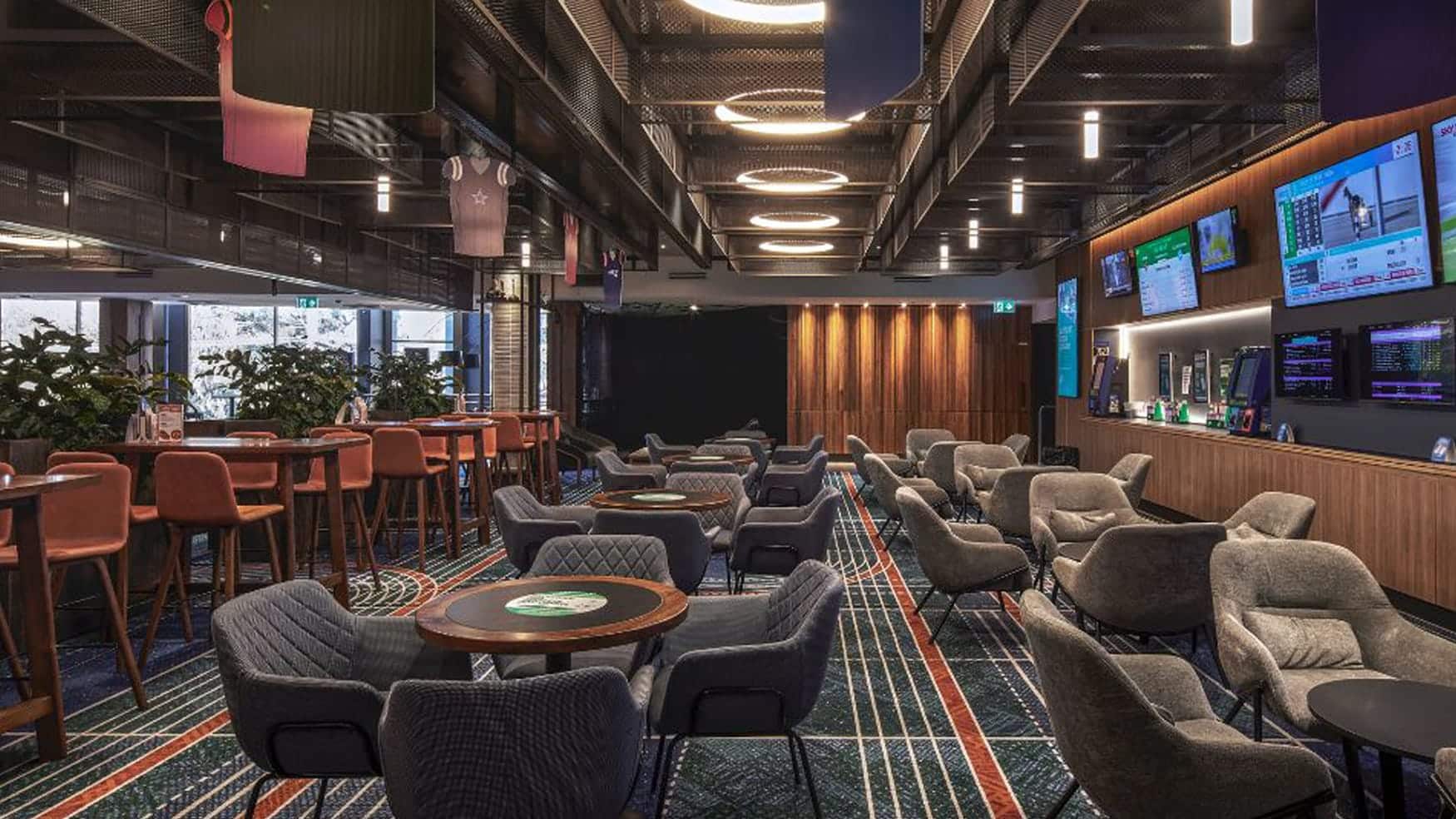 Lounge seating and racing screens in the watch room at Sports Arena