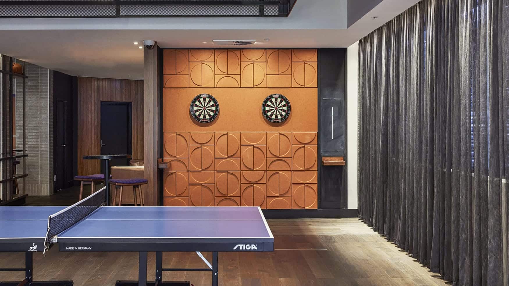Ping pong table and dartboards in the gaming room at Sports Arena