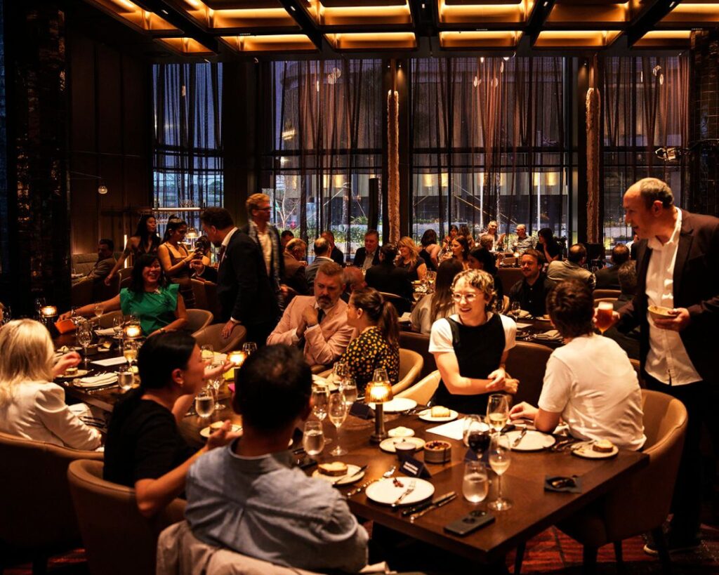 Busy MAGMA dining room with groups sharing dinner, an easy night out for group bookings at Novotel Sydney Cabramatta