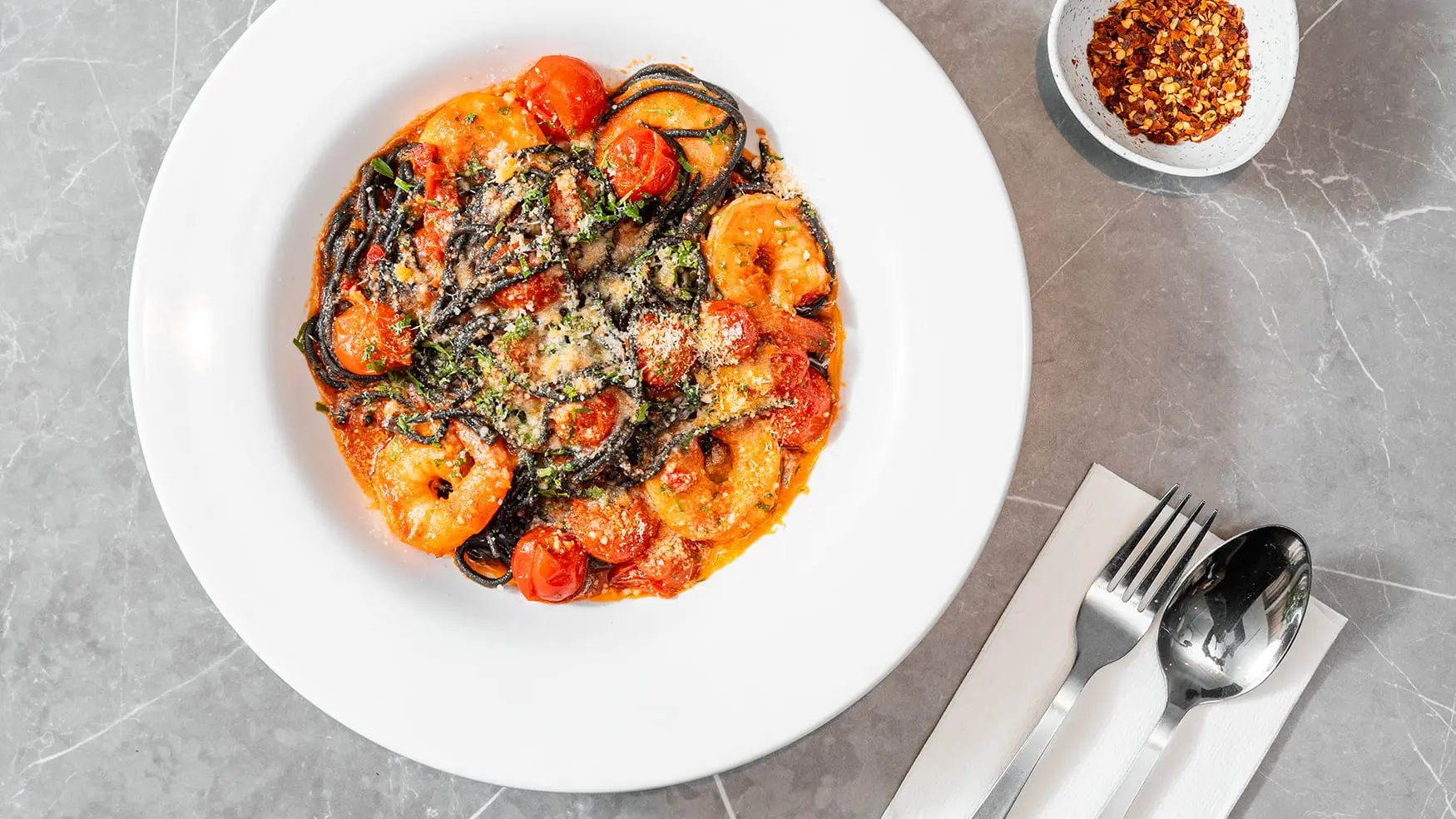 Garlic prawns and tomato black linguine with seared prawns at Bistro 1925