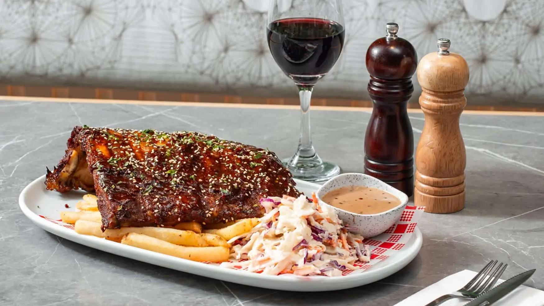 BBQ pork ribs served with coleslaw, chips and pepper sauce at Bistro 1925