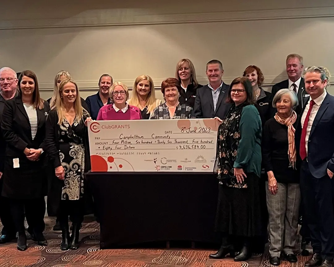 Cabravale Representatives and recipients gather at the ClubGRANTS Presentation 2023 at Campbelltown Catholic Club, holding a large grant cheque supporting local initiatives