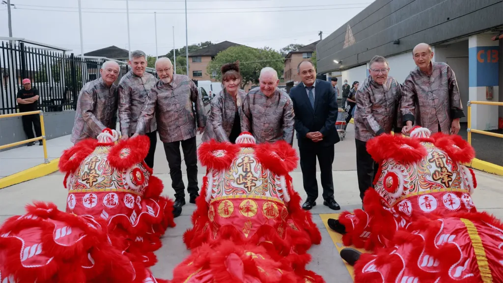 Cabravale Club Resort board of directors pose with red lion dance performers celebrating Chinese New Year festivities