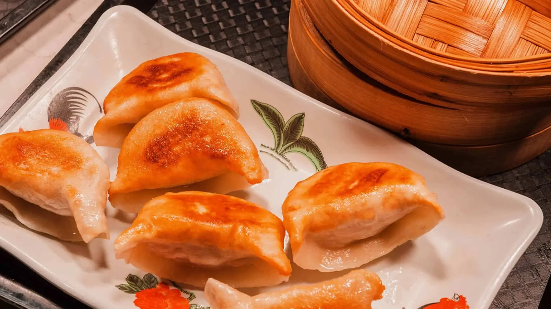 Pan-fried potstickers dumplings served on a plate at District 8 Asian restaurant in Cabravale Club Resort.