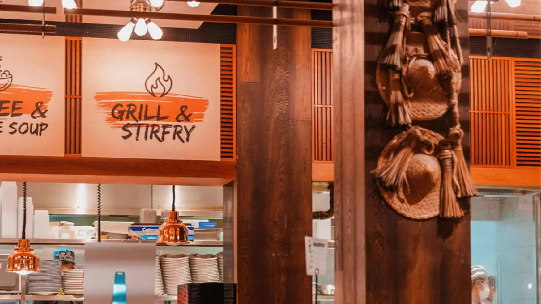 Interior dining sign showing “Grill & StirFry” at District 8.