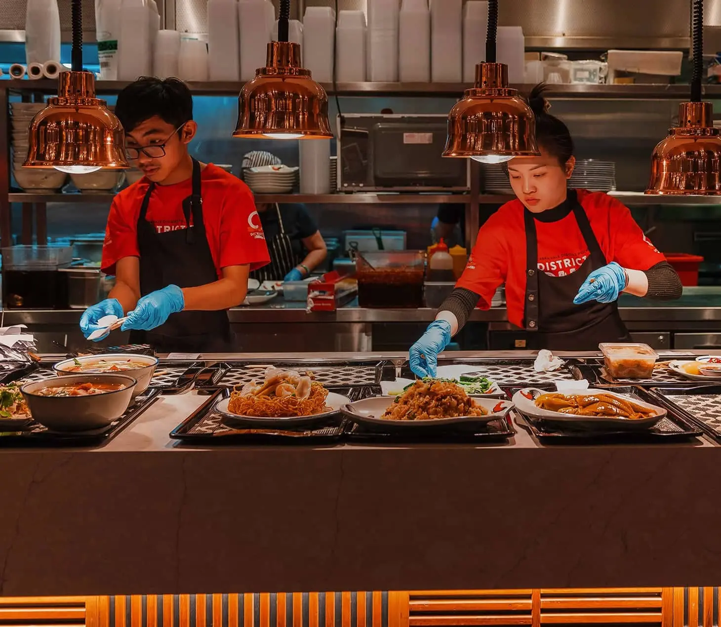 Chefs preparing Southeast Asian cuisine at District 8 in Cabravale Club Resort.