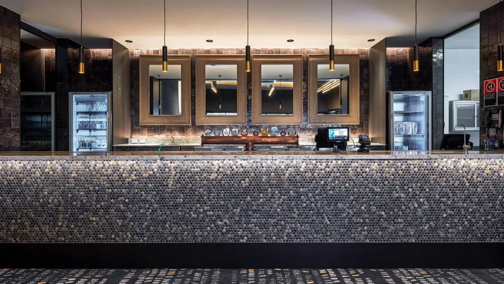 Mosaic-tiled bar with mirrors and beer taps, available for events at the Cabravale Events & Conference Centre