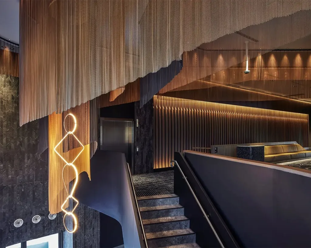 Event venue interior with sculptural lighting, timber finishes and a grand stairway in Western Sydney