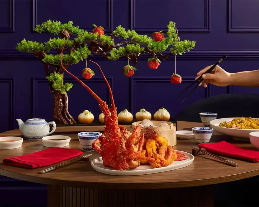 Lobster banquet with a bonsai centrepiece and red napkins, set for a private function at Cabravale