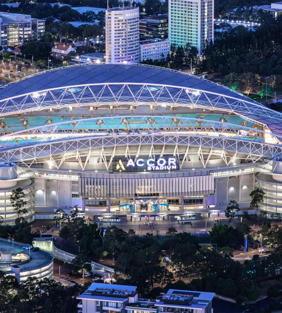 Aerial view of Accor Stadium at Sydney Olympic Park at night, a major events venue to explore from Cabravale