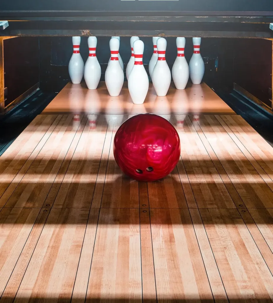 Red bowling ball rolling toward the pins at 710 Split bowling alley, a fun outing near Cabravale