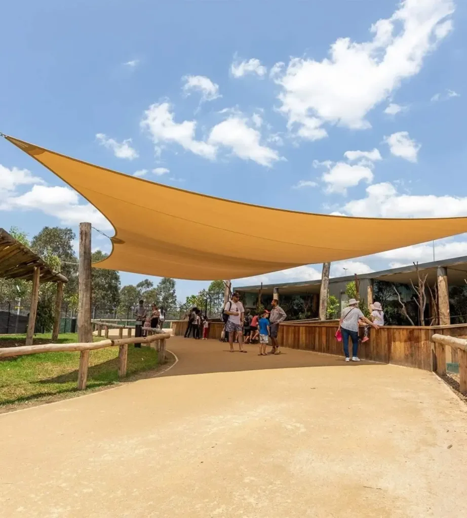 Visitors on a shaded walkway at Sydney Zoo, a family day out near the Western Sydney hotel