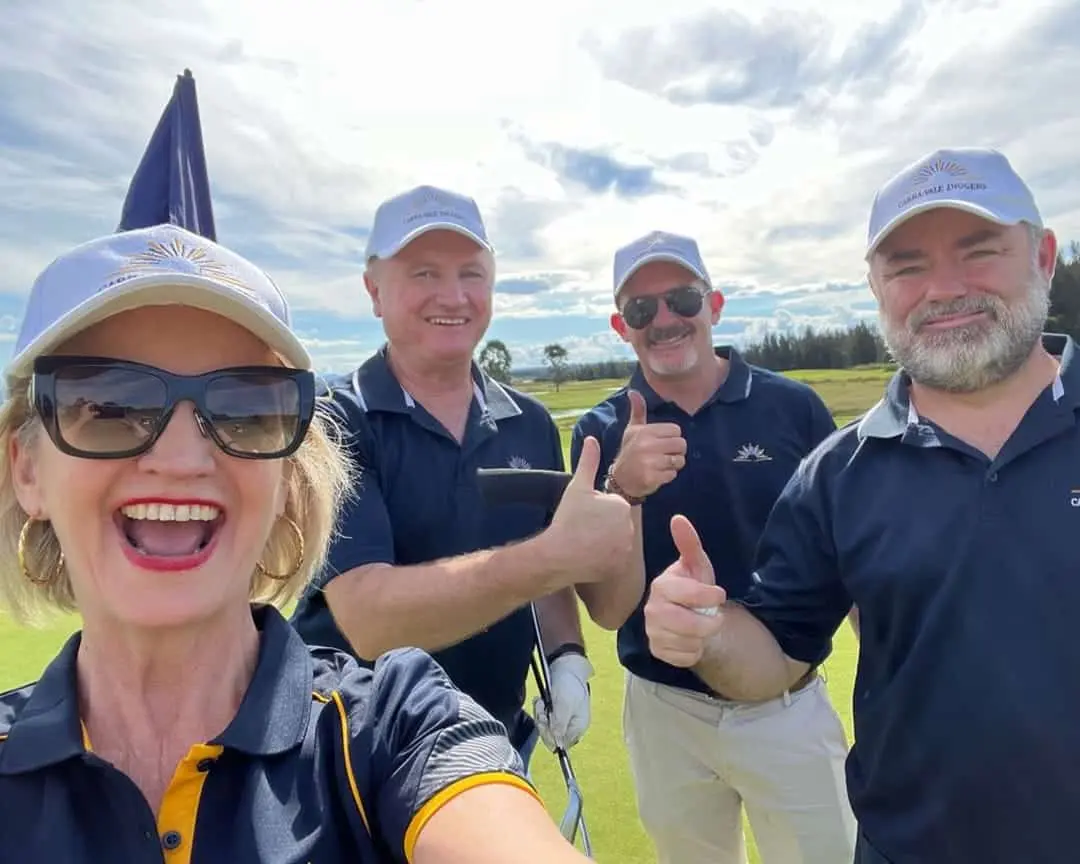 Four Cabravale Club Resort team members smile and give thumbs up on a golf course at Lynnwood Golf & Country Club during a charity golf day.