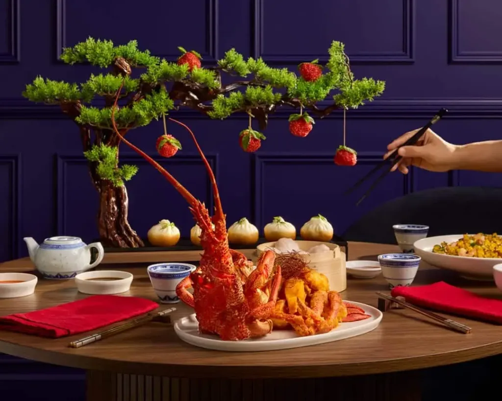 Lobster banquet with a bonsai centrepiece and red napkins, a group dinner option with group accommodation in Sydney