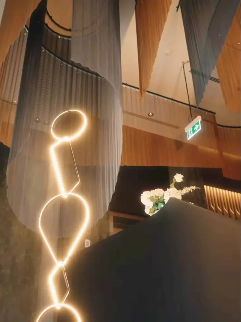 Glowing sculptural light feature and draped ceiling inside the functions space at Cabravale Club Resort