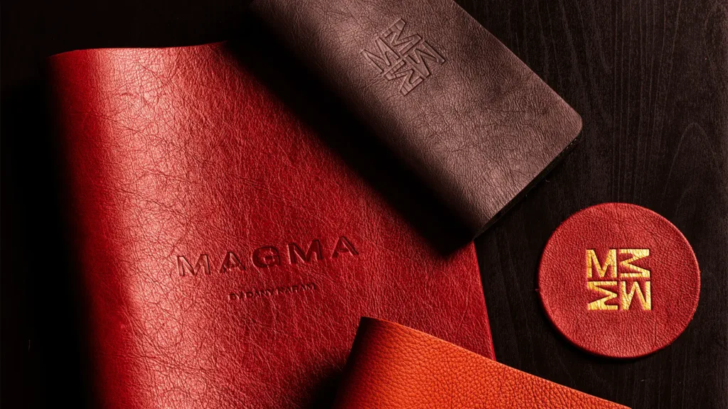 Embossed leather menu and coaster featuring Magma by Dany Karam branding
