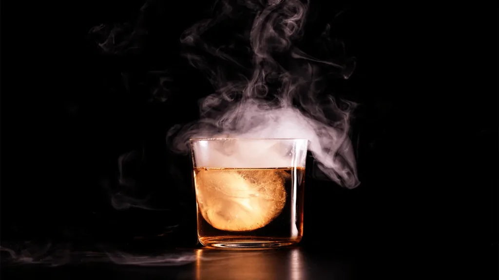Smoked cocktail served over a large ice cube at Magma by Dany Karam