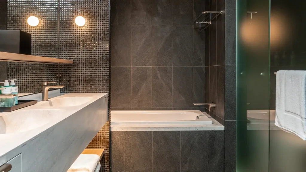 Superior King bathroom with a soaking tub, shower and stone vanity at Novotel Sydney Cabramatta