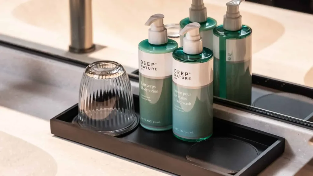 Deep Nature hand wash and body lotion displayed on stone vanity in Novotel Sydney Cabramatta bathroom