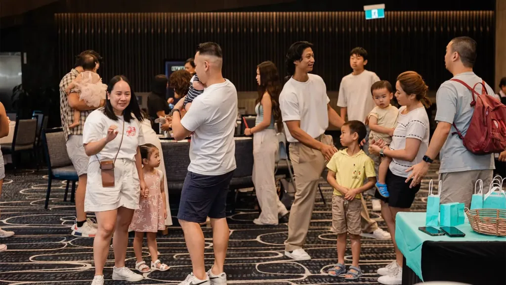 Families mingling by banquet tables and children’s play zone, highlighting adaptable function rooms in Western Sydney.
