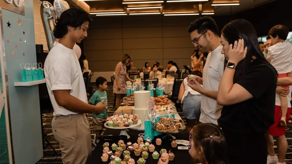 Guests browsing a dessert table of cupcakes and treats at a private function at Cabravale Club Resort