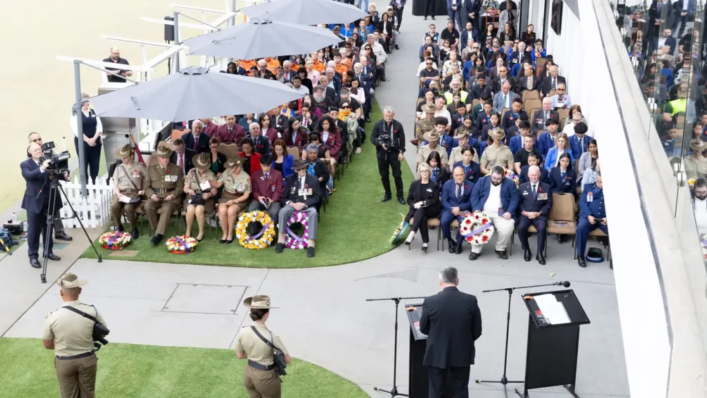 Large crowd of veterans, dignitaries and community members seated at Cabravale Club Resort Remembrance Day ceremony.