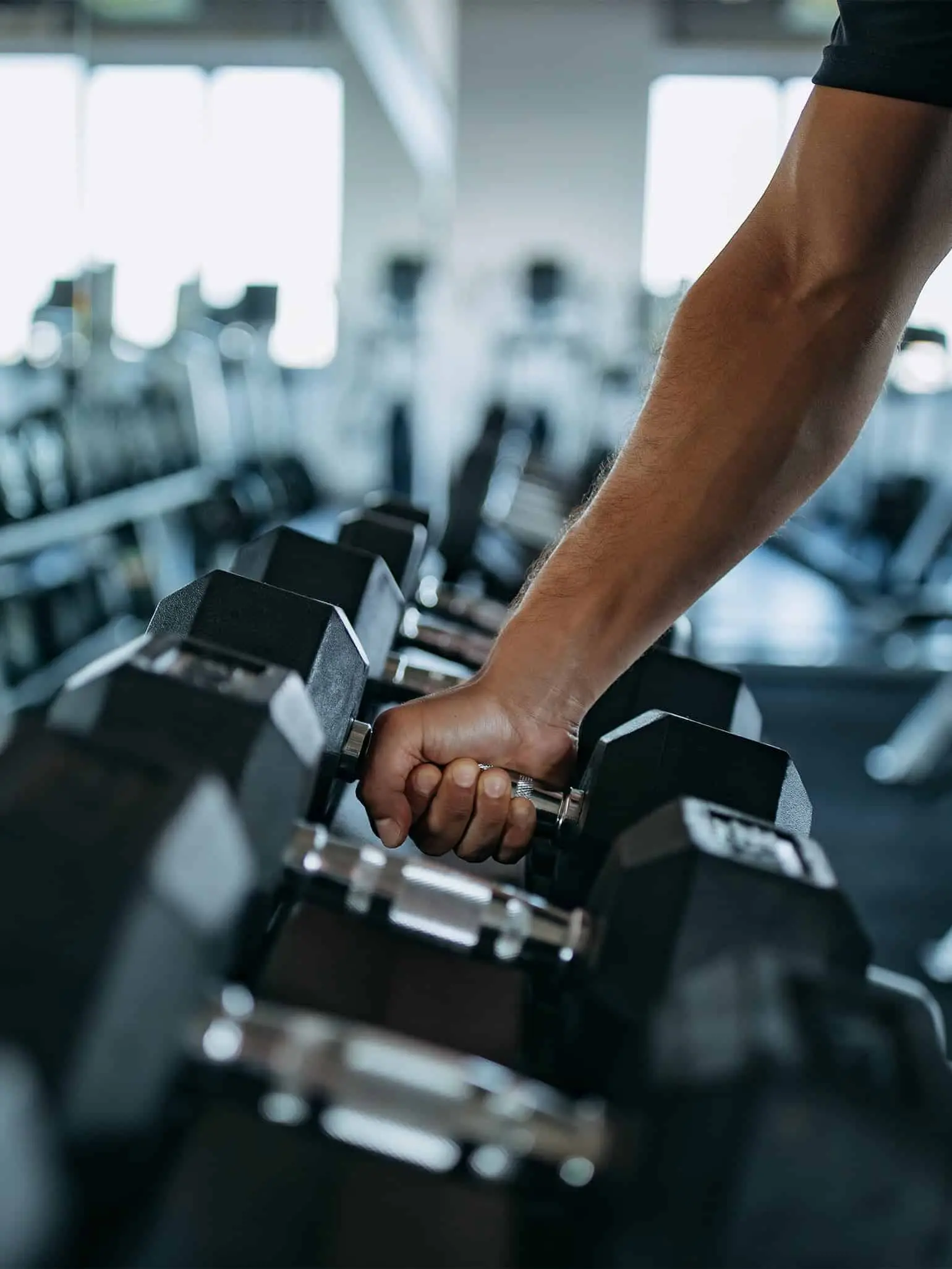 Hotel gym with free weights and fitness equipment