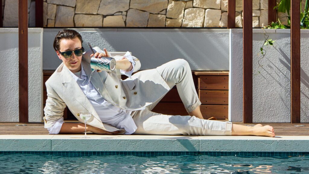 Guest enjoying a signature cocktail by the pool at Solaire Lounge