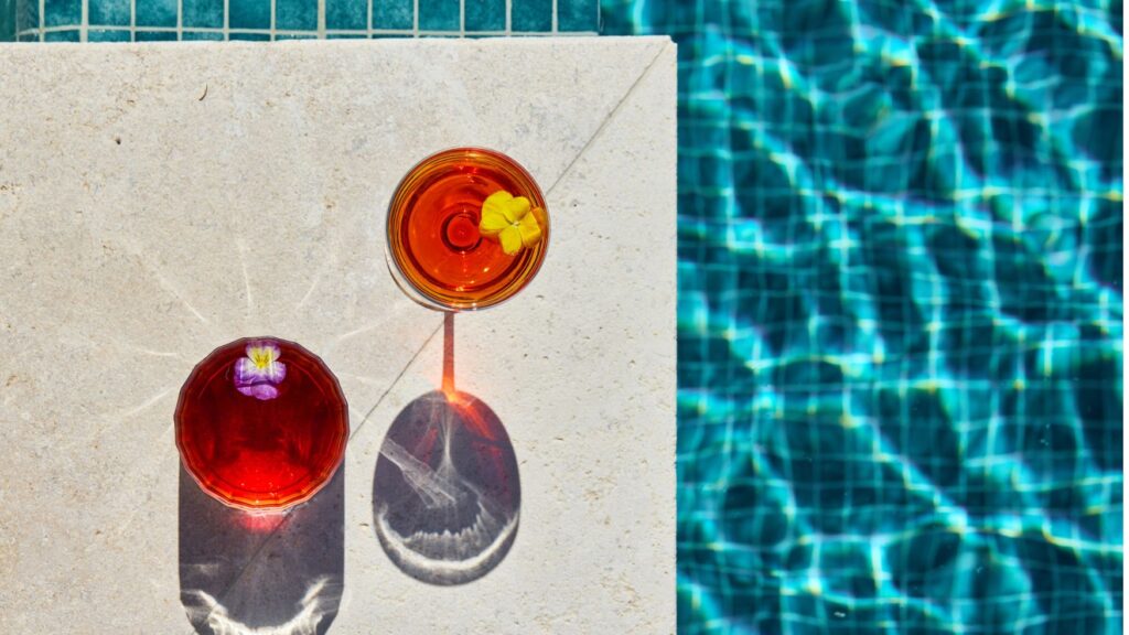Poolside cocktails on a stone ledge beside the swimming pool at Solaire Lounge