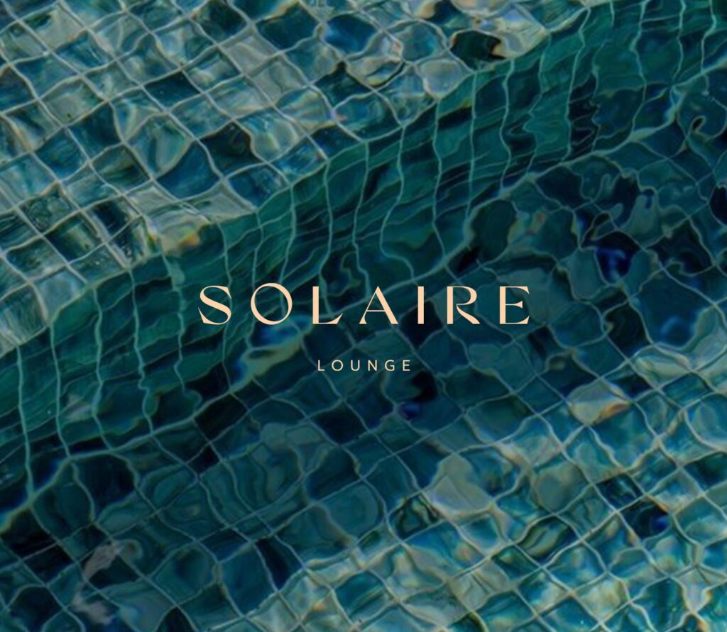 Solaire Lounge branding over pool tiles at Cabravale Club Resort, showcasing a luxury poolside dining atmosphere