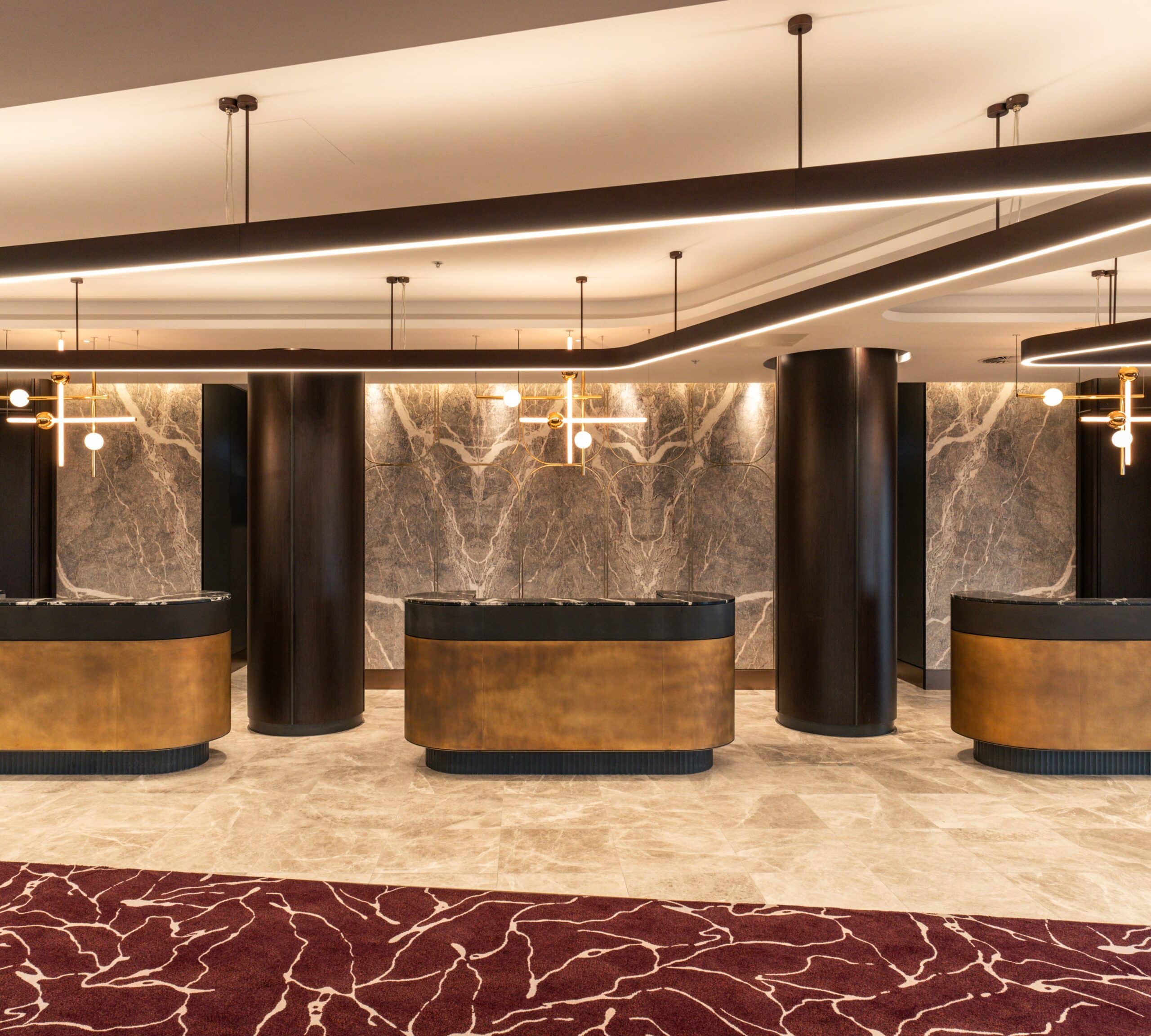 A refined hotel lobby at Cabravale Club Resort, showcasing contemporary design with warm lighting, marble finishes, and spacious reception areas that set the tone for comfortable group stays and seamless check ins.