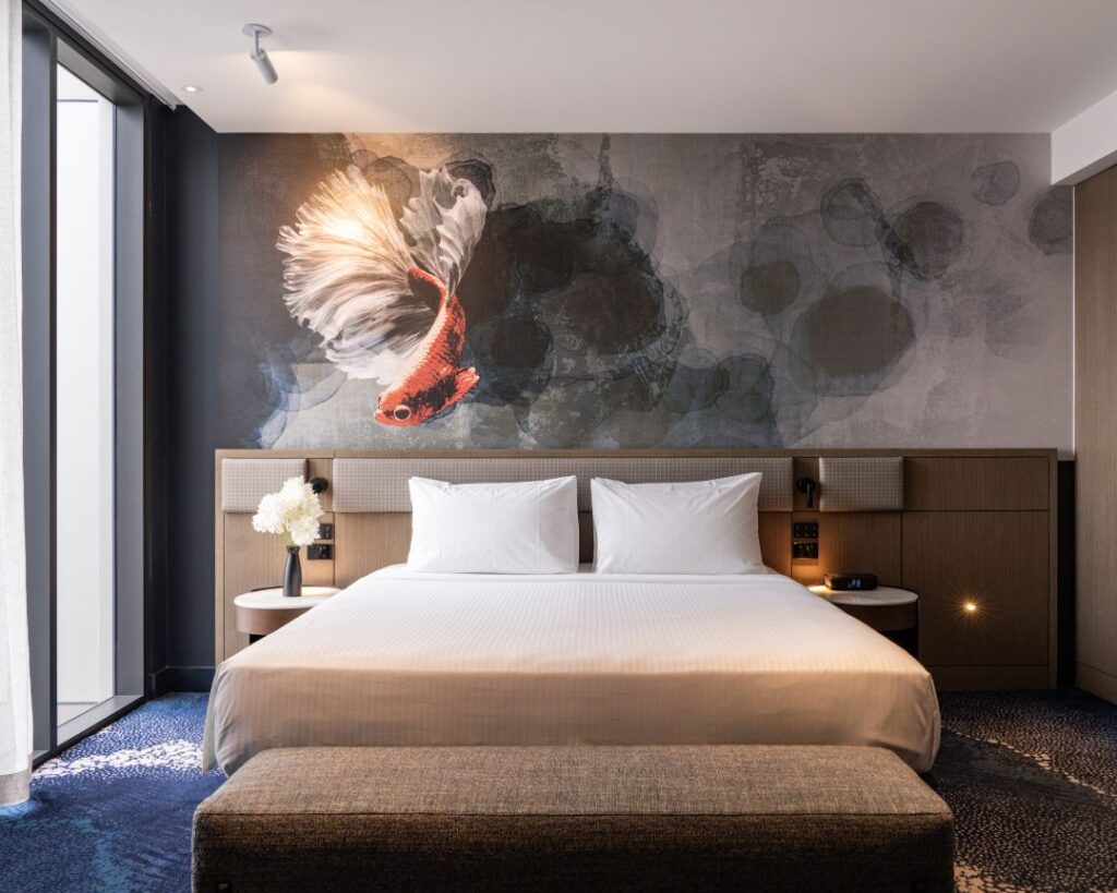 Hotel Room with Koi fish mural, balcony window and plush bedding at Novotel Sydney Cabramatta