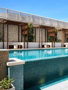 Outdoor hotel pool with private cabanas in Western Sydney