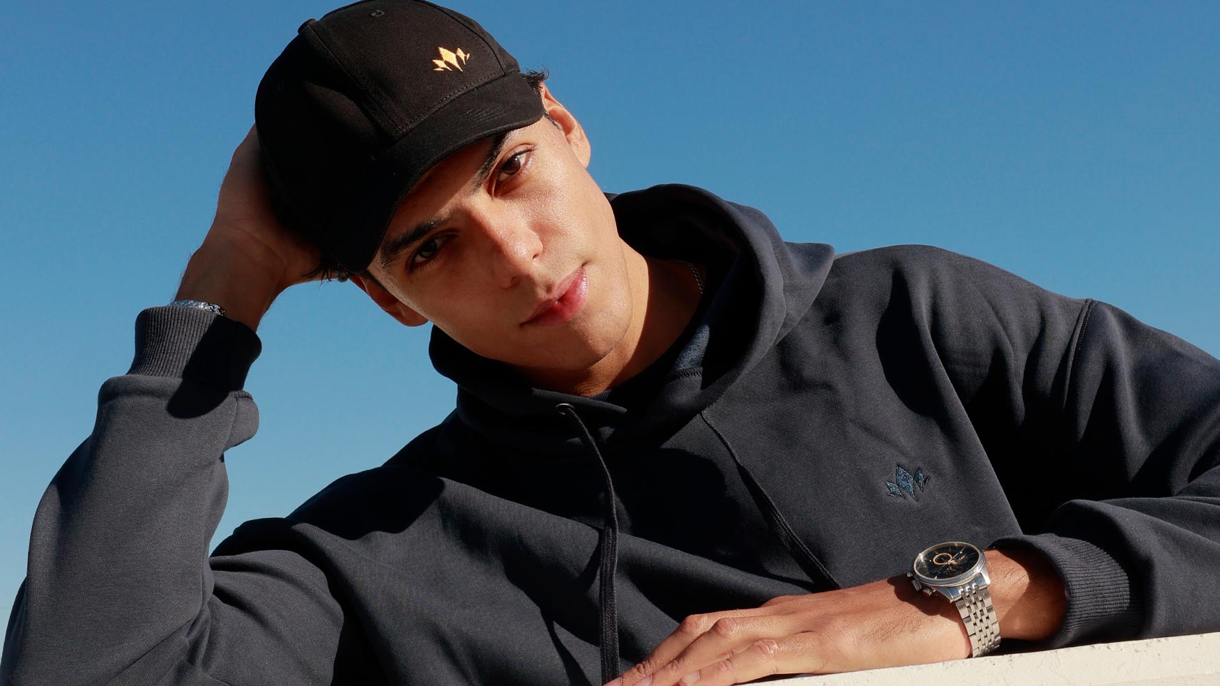 Man wearing dark Cabravale Boutique cap and jacket