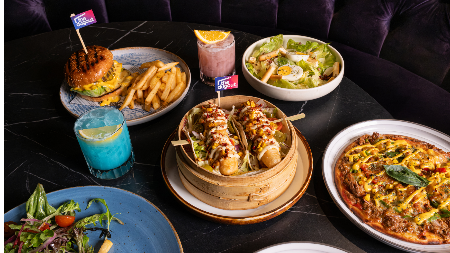 burgers and fish tacos with cocktails and pizza at sports bar