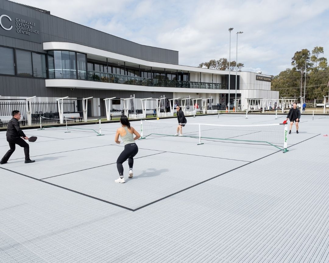 Group of four playing pickleball
